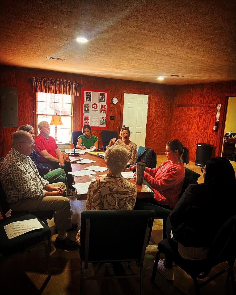 Morgan Cares Center board members meeting around a table at the Morgan Cares Center.