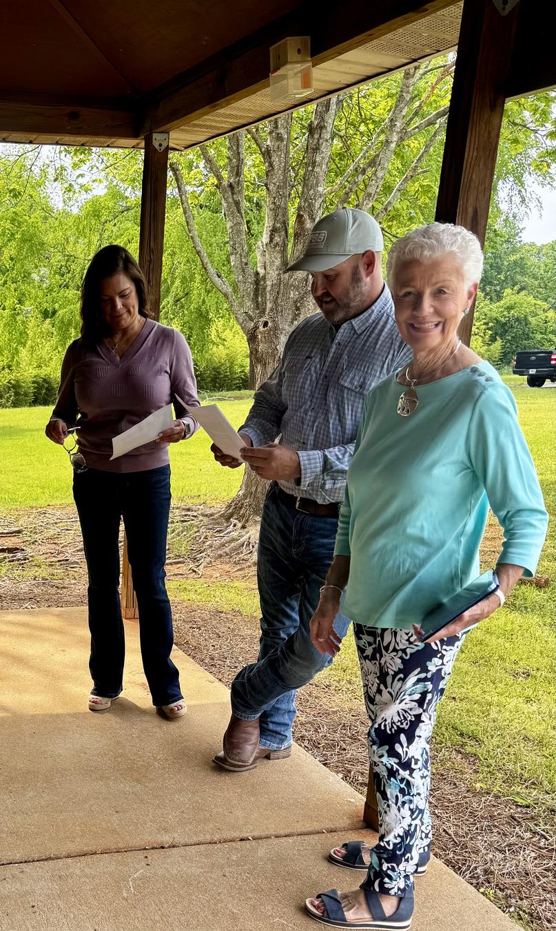 Morgan Cares Center volunteers going over paperwork together outside a community pavilion.